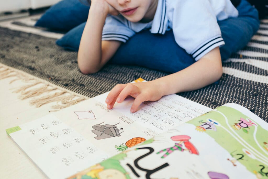 boy-reading-textbook-floor