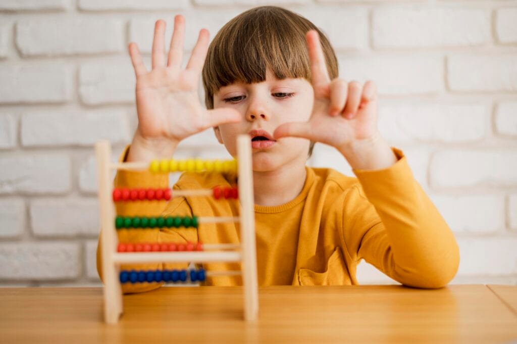 Young child practicing counting with colorful abacus – holistic abacus learning at Achiever’s Destination Academy