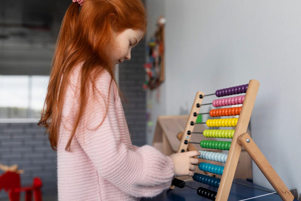 Young girl learning with colorful abacus – benefits of abacus classes for kids